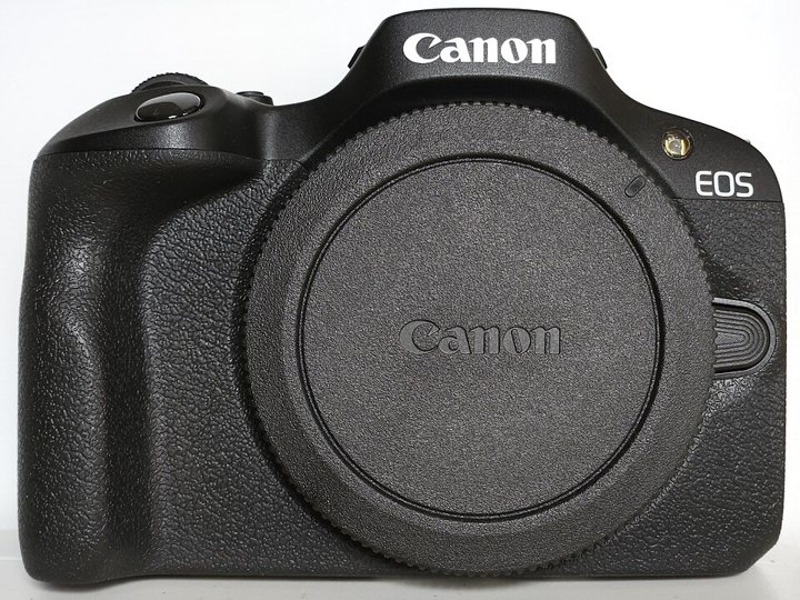 Canon EOS R100 camera with its 18–45mm kit lens attached.
