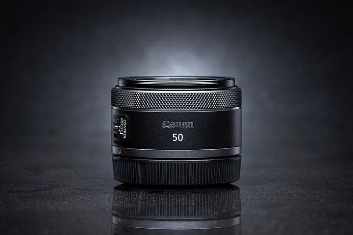 Canon RF 50mm f/1.8 STM lens, a small black prime lens.