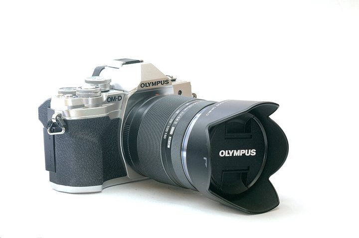 OM System E-M10 Mark IV camera with a silver top plate and dials.