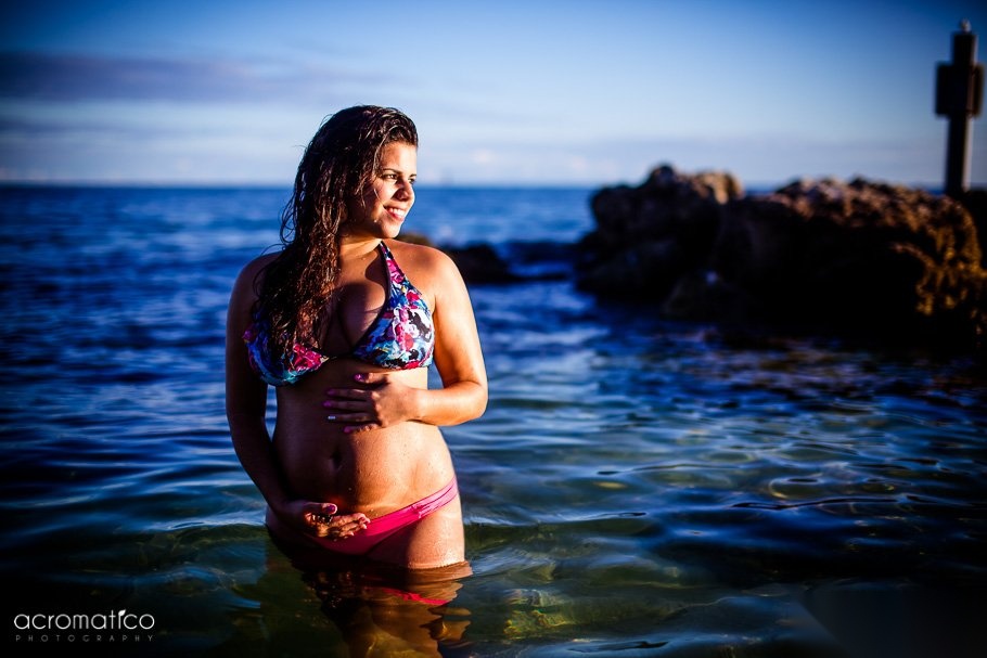 Expectant mother in a flowing dress posing outdoors during a Key West maternity session