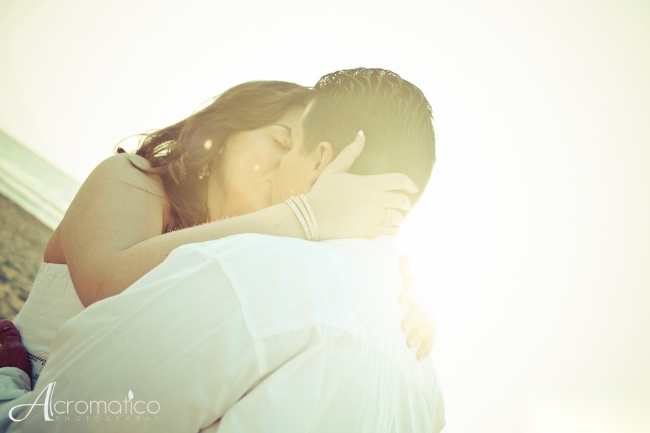 Engaged couple walking along Hollywood Beach during their engagement session