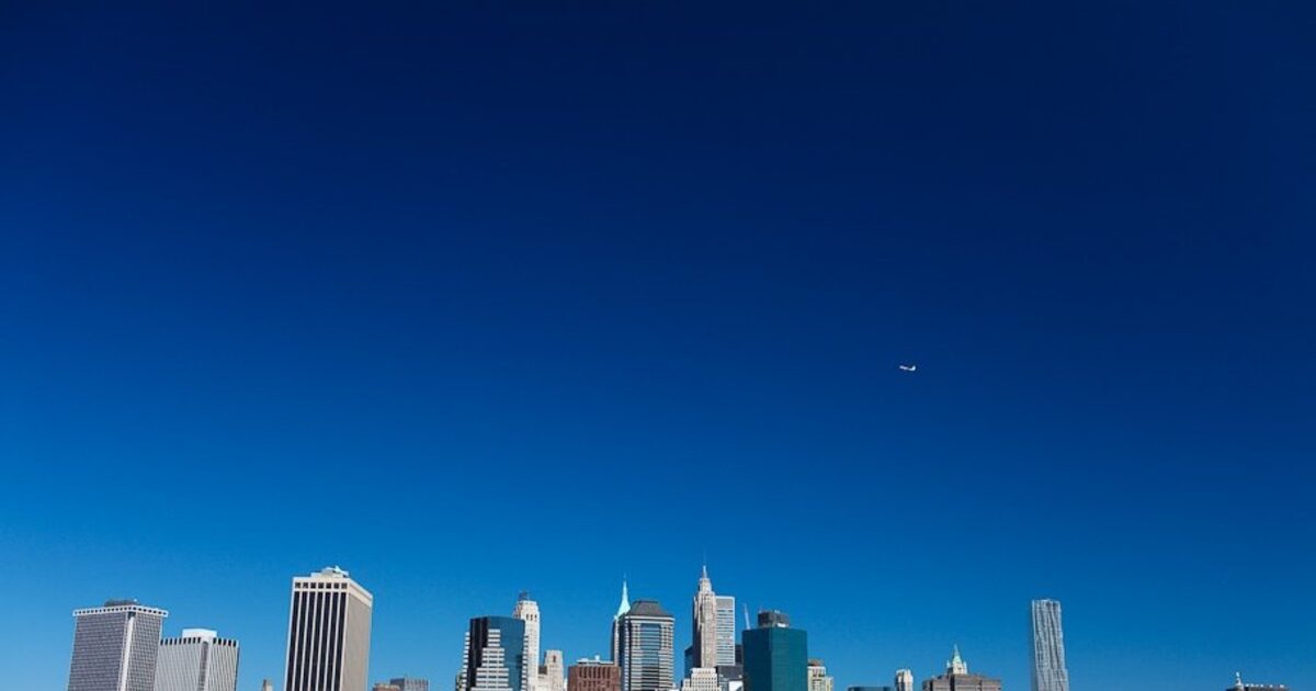 Brooklyn Bridge cables converging toward the Manhattan skyline, dozens of lines meeting at one point